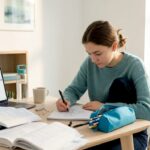 Student planning science investigation at kitchen table