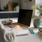 Hands adjusting graph settings on laptop