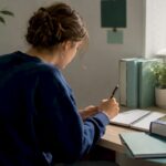 Student writing ESS IA evaluation notes