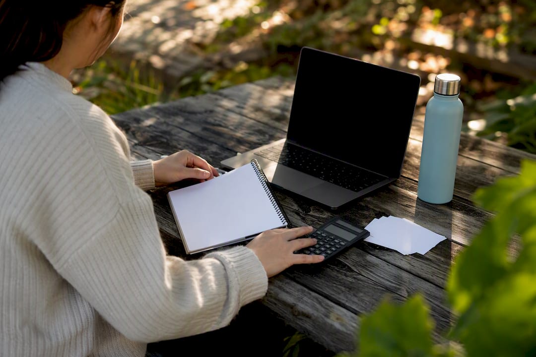 Student hands arranging ESS essay tools at study nook