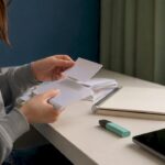 Hands arranging sticky notes for study plan
