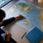 Hand annotating routes on a geography map