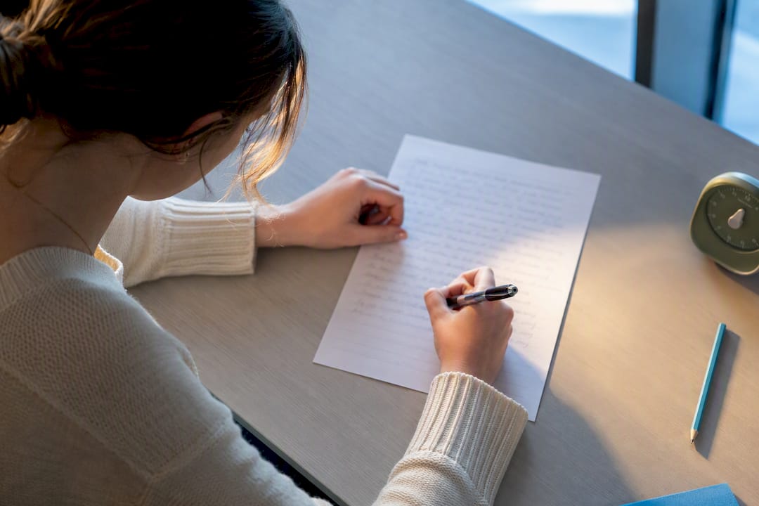 Student writing an ESS essay paragraph