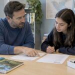 Tutor and student reviewing ESS IA examples