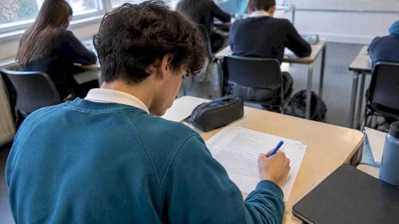 Student annotating an IB ESS exam response