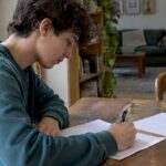 Student writing a concise exam practice answer